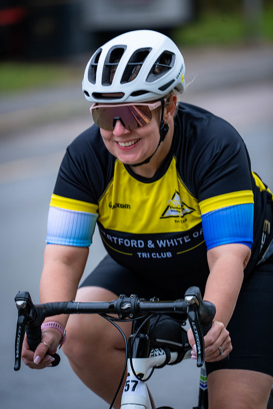 Club cyclist smiling on the bike leg of the Dartford and White Oak Triathlon
